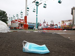 A discarded mask remains as the 2021 Calgary Stampede clean up and tear down began on Monday, July 19, 2021.