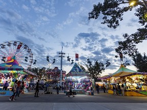 Dusk falls on the midway at the Calgary Stampede on Tuesday, July 13, 2021.