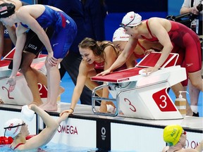 Canada's Rebecca Smith, Kayla Sanchez, Margaret MacNeil and Penny Oleksiak celebrate a silver medal in the women's 4 x 100m freestyle relay during the Tokyo Olympics in Tokyo, Japan on Sunday, July 25, 2021.