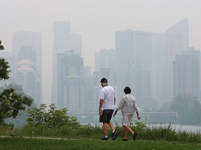 It was another smoke shrouded day in the city as Calgarians exercised on the Bow River pathway on Monday, July 19, 2021.