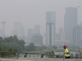 The smoke shrouded downtown Calgary skyline is seen over the lunch hour on Monday, July 19, 2021.