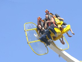 People enjoy a midway ride during Sneak-a-Peak as the 2021 Calgary Stampede kicked off on Thursday, July 8, 2021. Darren Makowichuk/Postmedia