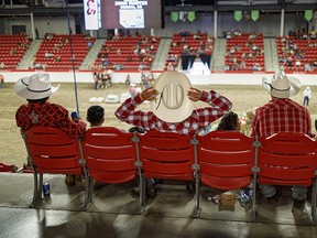 Socially distanced one cowboy-hat width apart at the heavy-horse pull at the Calgary Stampede on Tuesday, July 13, 2021.