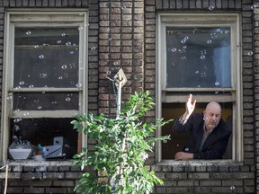 Jonathan Sunstrum  puts on his 'bubble ballet' show from his second-floor loft apartment overlooking the 1 St SW LRT station in downtown in this April 26, 2015 file photo.