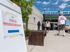 People line up for COVID-19 vaccinations at Genesis Centre in northeast Calgary on Tuesday, June 15, 2021.