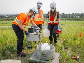 University of Calgary researchers check monitoring equipment as they track traces of COVID-19 in the wastewater system in  Calgary on Wednesday, July 14, 2021.