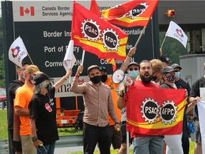Border Services officers and union officials during a mid-day demonstration in Cornwall. Border agents ended a work-to-rule action late Friday after reaching a tentative agreement with the federal government.