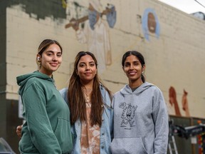 From left: Zoe Harveen Kaur Sihota, Ravina Toor, Harneet Kaur Chahal stand in front of the mural they are painting in solidarity with  farmers' protests in India. The work, part of the BUMP mural festival, is expected to be completed by Aug. 16, 2021.