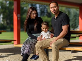 Jihan, left, and Sharif Sharifi and their two-year-old son Armaan pose for a photo at South Calgary Park on Friday, August 27, 2021.