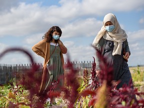 Souzan Korsha, settlement councillor with CCIS, left, and her mother Fadia Korsha explore the gardens at the Land of Dreams urban farm during the CCIS 40th anniversary family fun day on Tuesday, August 31, 2021. Land of Dream urban farm is a project aiming to support refugee and immigrant families by providing space for newcomers to cultivate connections in the local community.