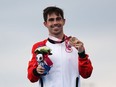 Bronze medalist Stefan Daniel of Team Canada reacts during the men's PTS5 Triathlon medal ceremony on day 5 of the Tokyo 2020 Paralympic Games at Odaiba Marine Park on August 29, 2021 in Tokyo, Japan.