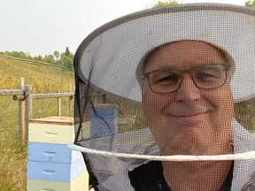 Herman Van Reekum at his apiary in the Millarville area, harvesting Bear Bait Honey. Supplied photo.