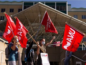 Nurses demonstrate against government rollbacks and short staffing levels outside of the Royal Alexandra Hospital in Edmonton, on Wednesday, Aug. 11, 2021.