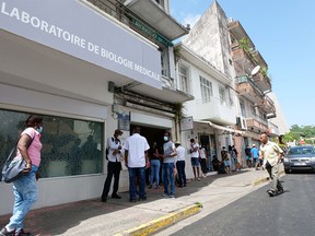 In this photograph taken on Aug. 2, 2021 local residents queue up to take a COVID-19 test at a laboratory in Fort-de-France, in the French Caribbean island of Martinique.