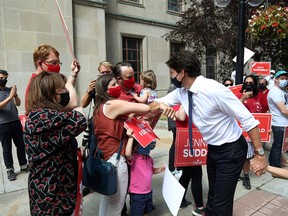 Canada's Prime Minister Justin Trudeau greets supporters during a walk to  his campaign bus on August 15, 2021 in Ottawa, Canada.
