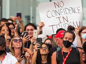 Protestors react while awaiting an election campaign visit by Canada's Liberal Prime Minister Justin Trudeau, which was cancelled citing security concerns, in Bolton, Ontario, Canada August 27, 2021.