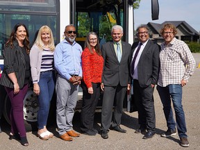 Calgary Mayor Naheed Nenshi (second from right) and Chestermere Mayor Marshall Chalmers (third from right) pose for a photo with Calgary and Chestermere council members after announcing a new transit link between the two municipalities. Monday, August 30, 2021.