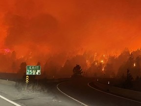 Fire burns within metres of the Coquihalla Highway on Sunday. Photo by BC Ministry of Transportation