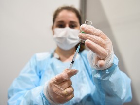 A medical worker fills a syringe with a dose of AstraZeneca's coronavirus disease (COVID-19) vaccine at the Belexpo vaccination centre in Belgrade, Serbia, March 27, 2021.