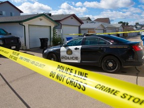 Calgary police contain the scene behind a home on Erin Circle S.E. after a suspicious death early Tuesday morning, August 24, 2021. 

Gavin Young/Postmedia
