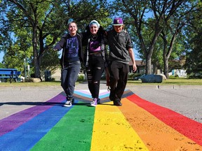 Jack James High School Grade 12 students from left; Percy, Maxx and Damien walk across the newly painted rainbow Pride crosswalk at the school on Wednesday, August 25, 2021. The crosswalk in the first permanent installation of its kind at a Calgary Board of Education school. The crosswalk is intended to be a symbol of support for members of the 2SLGBTQ+ community.