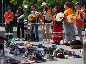 Members of the Bear Clan sing and drum at the Calgary City Hall memorial for children who did not return home from residential schools on Thursday August 26, 2021.