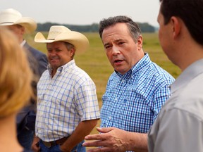 Alberta Premier Jason Kenny speaks with members of the Severtson family after announcing new drought support for Alberta ranchers and farmers on Friday, August 6, 2021. Dean Pilling/Postmedia.
