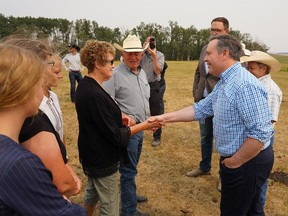 Alberta Premier Jason Kenny speaks with members of the Severtson family after announcing new drought support for Alberta ranchers and farmers. Friday, August 6, 2021. Dean Pilling/Postmedia