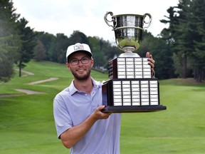 Riley Fleming, a teaching professional at Lynx Ridge in Calgary, lifts the P.D. Ross Trophy after winning the 2021 BetRegal PGA Championship of Canada. (Courtesy of PGA of Canada)