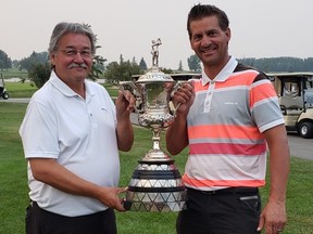 Calgary Golf Association president Rick Heenan (left) presents the trophy to Jamie Welder, now a five-time winner of the City Amateur. Welder won by eight strokes.
