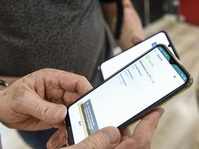 A person displays a health pass on a smartphone in Amneville, France, on July 22, 2021. French cinemas, museums and sports venues have begun asking visitors for proof of COVID-19 vaccination or a negative test.