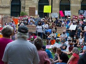 Calgarians protesting the recent Alberta Health Services changes ending testing and restrictions for COVID-19 rallied at the McDougall Centre on Sunday.