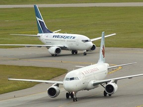 Passenger jets taxi on a runway at Calgary International Airport.