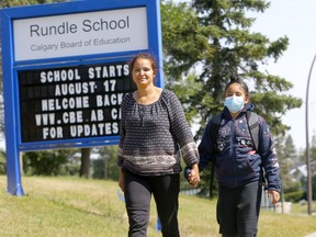 Mom, Prabhjot Sandhu picks her son, Harnoor, 9, from his Grade 5 classes at Rundle School as the Calgary Board of Education will mandate indoor face mask use for all students and staff when the traditional school year begins on September in Calgary on Wednesday, August 18, 2021.