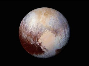 The former planet of Pluto is pictured in a handout image made up of four images from New Horizons' Long Range Reconnaissance Imager (LORRI) taken in July 2015 combined with color data from the Ralph instrument to create this enhanced color global view.  NASA/JHUAPL/SwRI/ photo, via Reuters.