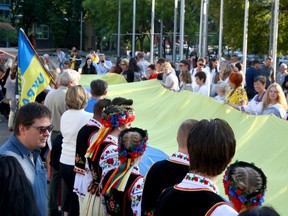 A 30 metre long flag is unfurled as several dozen people gather at City Hall for a flag raising ceremony to commemorate the 30th anniversary of Ukraine's Independence. Tuesday, August 24, 2021. Brendan Miller/Postmedia