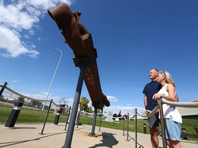 Mike and Daphne ter Kuile look at a piece of the World Trade Center displayed outside The Military Museums in Calgary on Sept. 9, 2021. Both served in the Canadian military and spent time in Afghanistan.
