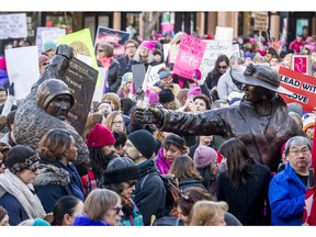 The Women are Persons! Famous Five sculpture stands amid a sea of mostly women during a women's march in Calgary a few years ago.  Today is the anniversary of the day when the Famous Five first met to work to secure recognition of women as persons under Canadian law. Postmedia file photo