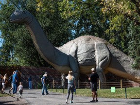 People spend the sunny afternoon at Brawn Family Foundation Dinny's Green featuring Dinny, the Calgary Zoo's popular Brontosaurus, on Friday, September 3, 2021.