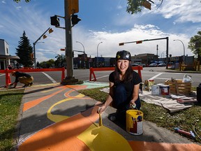 Artist Yiting Hui paints the sidewalk art on the intersection of 8th Ave. N.E. and Edmonton Trail, which is a part of the Art Cycle Routes project decorating sidewalks and bike paths from 2nd St. N.W. to 16 St. N.E., on Saturday, September 4, 2021.