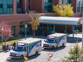 Two ambulances parked outside the west entrance at Peter Lougheed Centre on Monday, September 27, 2021.