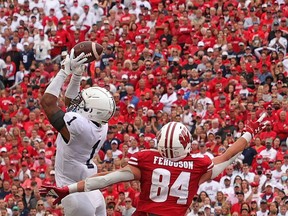 Jaquan Brisker, of the Penn State Nittany Lions, intercepts a pass intended for Jake Ferguson, of the Wisconsin Badgers, during the second half at Camp Randall Stadium on Saturday in Madison, Wis.