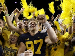 The Michigan Wolverines' Aidan Hutchinson celebrates a recent 31-10 win over the Washington Huskies with fans at Michigan Stadium.