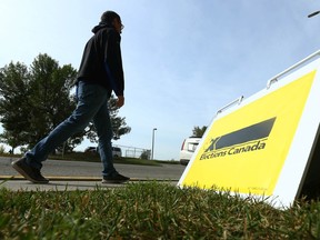 A pedestrian walks by a sign outside an Elections Canada office on 17 Ave SE in Calgary on Friday, September 10, 2021.