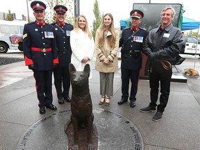 (L-R) Calgary Police Canine Unit members Sgt Ian Vernon, Sgt Jim Gourley, donors Tani Zeidler and Julia Tops, Chief Mark Neufeld and former dog handler Garth Blais pose during the ceremony and grand opening of the Calgary Police Canine Park in Calgary on Wednesday, September 15, 2021 outside the YouthLink Calgary Police Interpretive Centre at police headquarters. Blais’ service dog Sirk died in the line of duty in 1989 and there is a plaque in the park honouring the police dog.