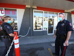 Calgary Police investigate at the scene of a drug store robbery at 1704 61 St SE in Calgary on Tuesday, September 21, 2021.