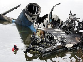 Russian rescuers and investigators work at the crash site of a plane with Russian ice hockey team Lokomotiv Yaroslavl aboard near in the city of Yaroslavl, 300 kilometres (185 miles) northeast of Moscow,  on September 8, 2011.