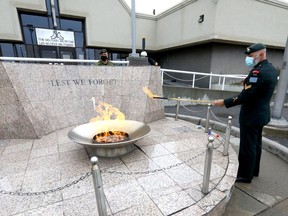 Corp. Andrew Mullett from the Princess Patricia's Canadian Light Infantry lights the cauldron at the Military Museums to mark the 20th anniversary of 9/11 with a public vigil ceremony in Calgary on Saturday, September 11, 2021.