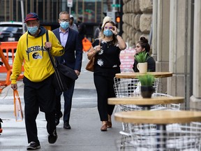 Calgarians wear masks while walking in downtown Calgary on Wednesday, September 15, 2021.