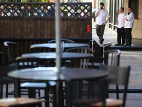 Hudsons pub chefs take a break along a quiet Stephen Avenue Mall over the lunch hour on Thursday, September 16, 2021. Alberta announced new COVID-19 restrictions which will affect restaurants starting on Sept 20.